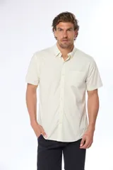 Camisa azul marino lisa de manga corta con cuello abotonado, cierre frontal con botones y bolsillo en el pecho. Confeccionada en algodón.