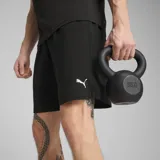 Short deportivo Puma negro con logo blanco estampado en la pierna izquierda.
