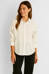 Camisa color crudo de viscosa con bordado de conchas marinas en gris, corte holgado, cuello camisero y cierre frontal con botones.