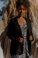 Blazer negro de lino con corte recto, solapas y cierre frontal con un botón.