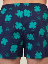 Bóxer de algodón blanco con estampado de flores pequeñas color celeste, con cintura elástica y logo de la marca en el centro.