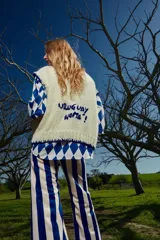 Camisa holgada con estampado de rombos azules y blancos, cuello solapa, manga corta y abotonada. Talle único, similar a un M.