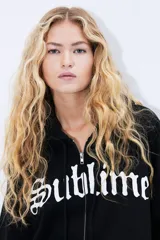 Campera negra con capucha y cierre frontal, con bolsillos tipo canguro y puños y cintura acanalados. Estampado frontal con el logo de la banda Sublime en color blanco.