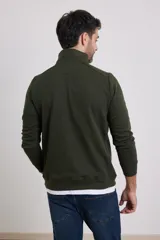Sweater color beige de tejido elastizado de algodón y poliéster, con medio cierre en el cuello, detalles de tela de algodón al tono y tirador de eco cuero.