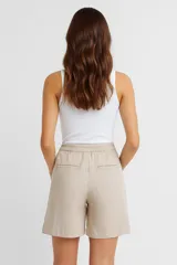 Short de lino de tiro alto, corte ancho y largo hasta la mitad del muslo, con estampado de rayas verticales blancas y azul oscuro.