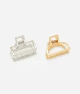 Set de dos pinzas para el pelo, una rectangular plateada y otra curva dorada.