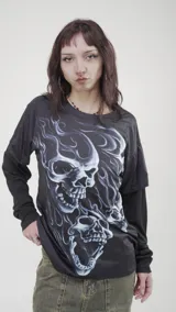 Remera negra de manga larga con estampado de calaveras en tonos azules y blancos.