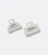 Set de dos pinzas para el pelo plateadas con incrustaciones de strass, una con forma de media luna y otra rectangular.