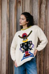 Sweater de lana merino color crudo, tejido y bordado a mano con diseño abstracto multicolor. Calce holgado, cuello a la base y puños acanalados.