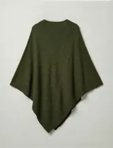 Poncho tejido de punto grueso, color mostaza/mostaza oscuro, con cuello redondo y caída amplia.