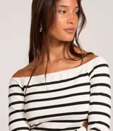 Blusa corta de manga larga con escote hombro a hombro y diseño a rayas horizontales blancas y negras.