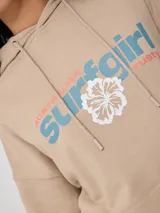 Canguro beige con capucha, estampado frontal con el texto "Australian Surfgirl Rusty" y un hibisco blanco.