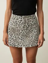 Falda corta de denim con estampado de leopardo, tiro medio y corte ligeramente acampanado.