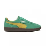 Championes Puma Palermo negros con detalles en blanco y suela color caramelo.