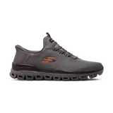 Championes deportivos Skechers Hands Free Slip-ins Glide-Step Noxus, color gris con detalles en naranja. Capellada de malla romboidal, cordones elásticos fijos, plantilla Skechers Air-Cooled Memory Foam y entresuela Glide-Step.