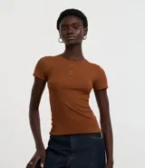 Blusa marrón de rib con cuello redondo y botones. De manga corta y corte ajustado.