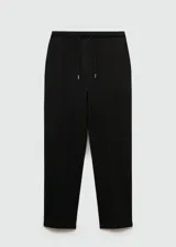 Pantalón negro de piqué con cintura elástica, tiro alto, diseño jogger, bolsillos laterales y costuras decorativas.