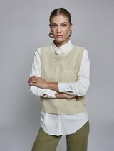 Chaleco de punto color beige con lurex, escote en V y sisas amplias.