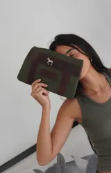 Sobre tipo cartuchera color borgoña, de lona con terminaciones en cuero marrón. Tiene cierre superior y aplique de cuero con el logo de la marca.