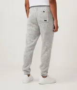 Pantalón de jogging gris oscuro con cintura elástica, cordón de ajuste, bolsillos delanteros y traseros, y tobillos ajustados.