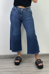 Pantalón jean azul oscuro, corte culotte, con tiro alto y terminación desflecada.