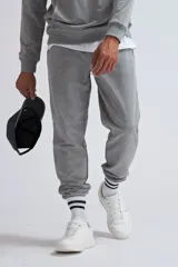 Pantalón deportivo de tejido de punto color gris claro melange, con puños ajustados en los tobillos y corte holgado.
