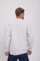 Buzo gris melange de manga larga y cuello redondo, con calce holgado y tejido de felpa suave en el interior.