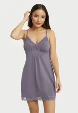 Chemise color violeta de seda fría, con breteles finos regulables y apliques de encaje en el escote y el ruedo.