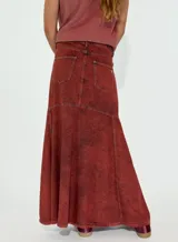 Pollera larga de jean color terracota con corte acampanado y paneles verticales.