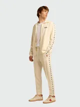 Remera de algodón color blanco roto con cuello redondo y un pequeño logo de estrella negra estampada en el pecho.