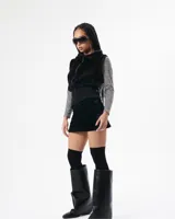 Chaleco negro de polar suave con cierre frontal y cuello camisero.