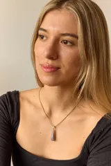 Collar dorado con cadena fina y dije colgante en forma de lágrima de piedra natural azul con vetas blancas.