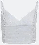 Blusa cropped blanca de laise con escote en pico, tirantes finos y bajo ancho.