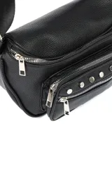 Riñonera color crema con correa ajustable negra, múltiples bolsillos con cierre y tachas decorativas.