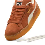 Championes Puma Suede XL color marrón con franja lateral blanca y suela de goma color caramelo.