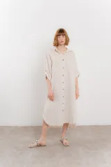 Vestido camisero midi color verde militar, de lino 100%, con silueta oversize, cuello camisero, mangas 3/4 con botón para ajustar y aberturas laterales.