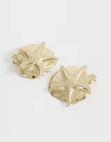 Set de dos hebillas doradas para el pelo con forma de concha marina y aplique de estrella de mar.