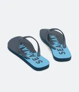Ojotas azules con base roja y estampa de la marca Seaman.
