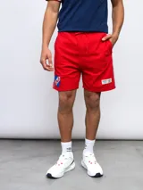 Bermuda deportiva roja con escudo del Club Nacional de Football y logo de Umbro.