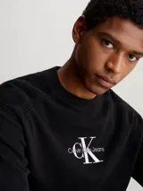 Sweater negro de algodón orgánico con cuello redondo y logo de Calvin Klein Jeans bordado en blanco en el pecho.