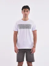 Remera blanca de corte slim fit con estampado frontal de líneas horizontales negras que forman la palabra 'Trust' y la frase 'In Yourself'.