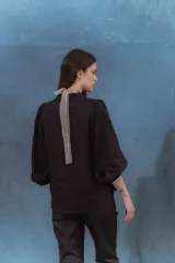 Camisa negra de lino con cuello mao, mangas abullonadas con elástico en los puños y botones forrados en la misma tela.