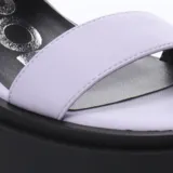 Sandalias negras con plataforma y taco cuadrado, con dos tiras anchas sobre el empeine y tira con hebilla al tobillo.