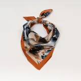 Pañuelo cuadrado de seda con estampado abstracto en tonos beige, azul, negro y marrón, con borde liso color ladrillo.