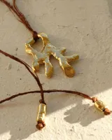 Collar con dije de bronce macizo con forma orgánica o de coral, suspendido de un hilo de seda natural color naranja.