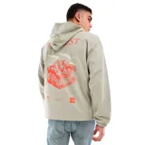 Hoodie gris de The North Face con capucha con cordón ajustable, corte oversize y estampado de montaña en la espalda.