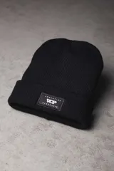Gorro de lana celeste con dobladillo y etiqueta negra con logo.