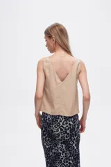Blusa color beige de poliéster, al cuerpo y con cuello en V.