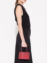 Mini bag en cuero vacuno graneado, con cierre metálico y forro de tejido jacquard, incluye un bolsillo plaqué.
