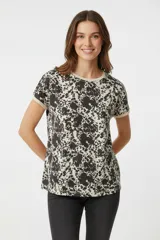 Remera de manga corta con estampado abstracto en blanco y negro, cuello redondo y corte holgado.